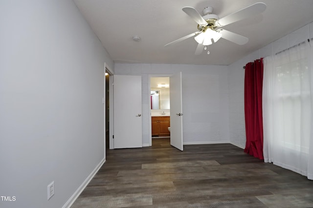 empty room featuring dark hardwood / wood-style flooring, ceiling fan, and sink