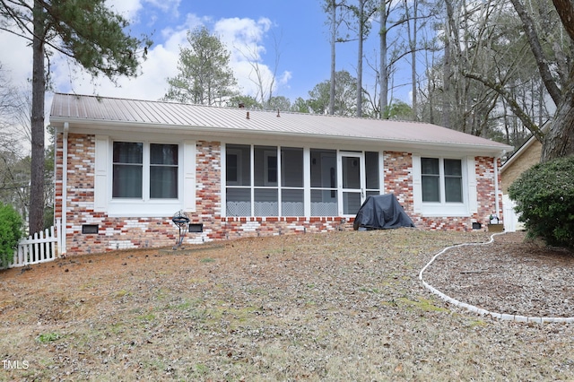 back of house with a sunroom