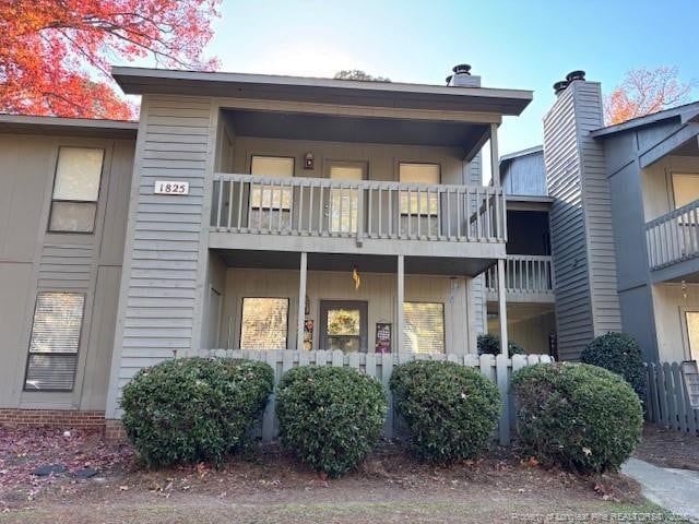 rear view of house featuring a balcony