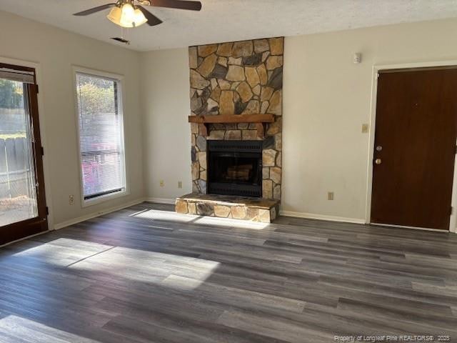 unfurnished living room with ceiling fan, a fireplace, and dark hardwood / wood-style floors