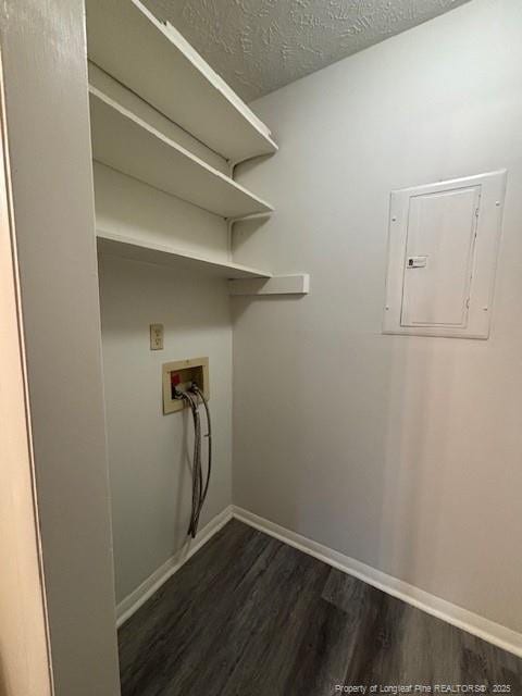 washroom featuring dark hardwood / wood-style floors, hookup for a washing machine, a textured ceiling, and electric panel