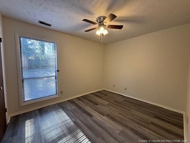 spare room featuring a textured ceiling, dark hardwood / wood-style floors, and ceiling fan