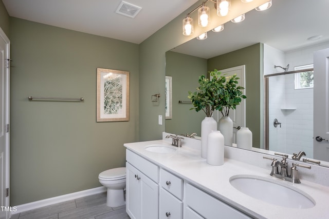 bathroom with vanity, an enclosed shower, and toilet