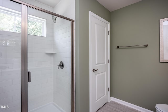 bathroom featuring toilet and walk in shower