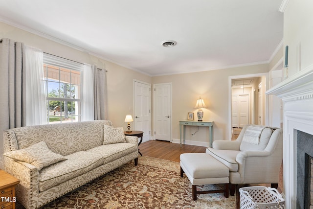 living room with hardwood / wood-style floors and ornamental molding