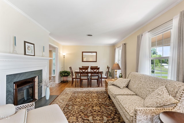 living room with hardwood / wood-style flooring and crown molding