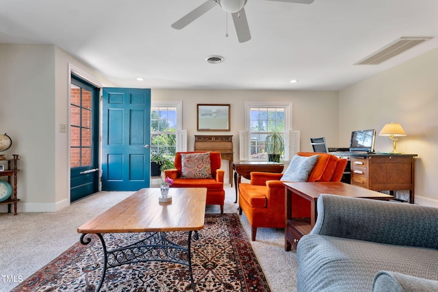 carpeted living room featuring ceiling fan