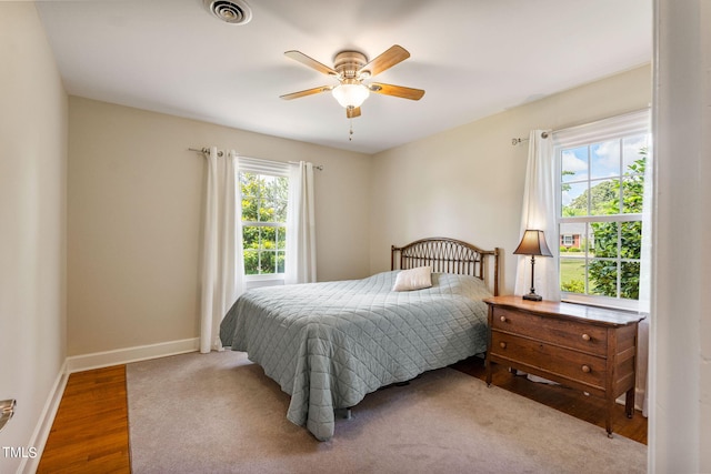 bedroom with ceiling fan and hardwood / wood-style flooring