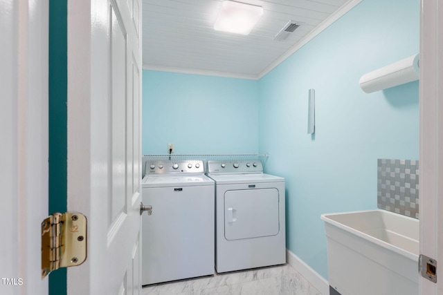 laundry room with sink, crown molding, and washing machine and clothes dryer