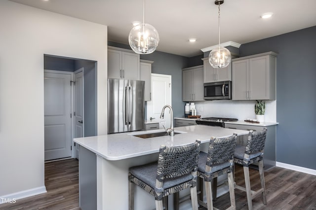 kitchen with decorative light fixtures, gray cabinets, sink, and stainless steel appliances