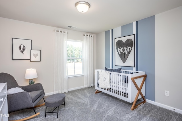 bedroom featuring carpet and a crib