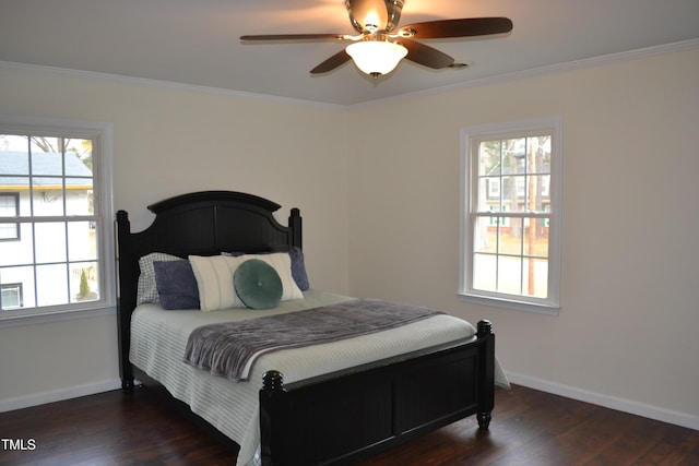 bedroom with dark hardwood / wood-style floors, ceiling fan, and crown molding