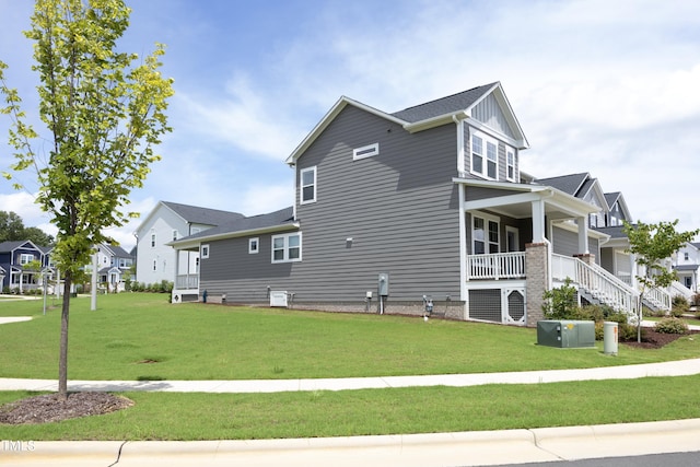 view of home's exterior with a porch and a lawn