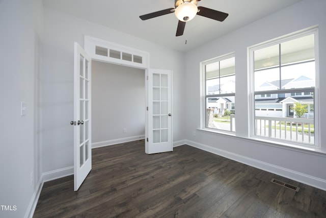 spare room featuring french doors, dark hardwood / wood-style floors, and ceiling fan