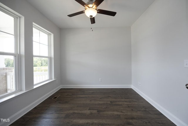 spare room with ceiling fan and dark hardwood / wood-style floors