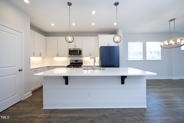 kitchen with white cabinetry, an island with sink, and stainless steel appliances