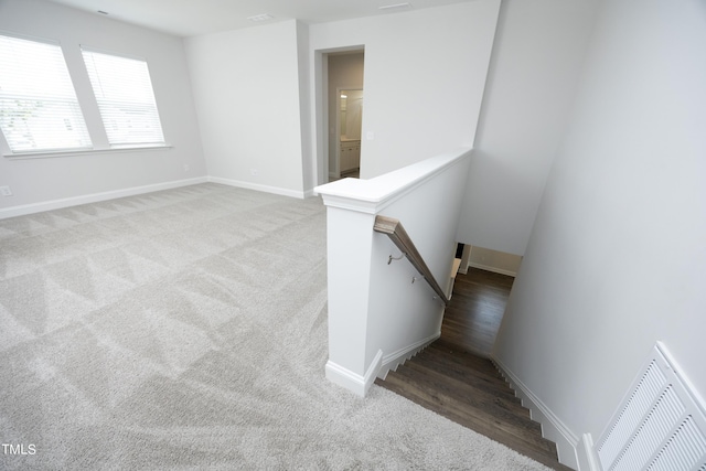 stairs featuring carpet