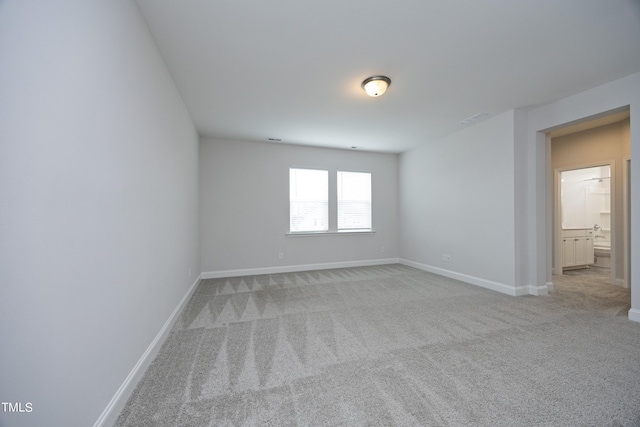 unfurnished room featuring light carpet