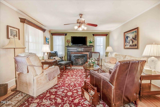 living room featuring hardwood / wood-style floors, ceiling fan, and crown molding