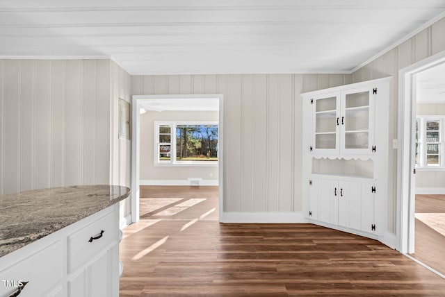 unfurnished dining area with dark wood-type flooring