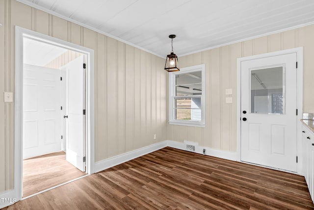 unfurnished dining area featuring wood-type flooring and ornamental molding