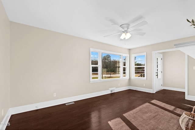 empty room featuring dark hardwood / wood-style flooring and ceiling fan