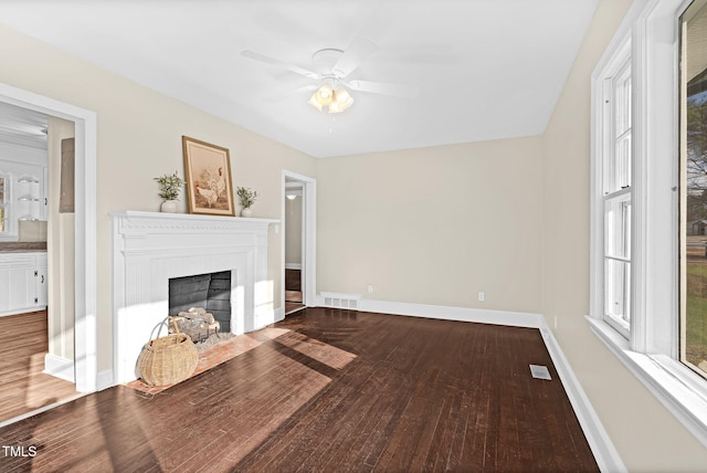 unfurnished living room with hardwood / wood-style flooring and ceiling fan