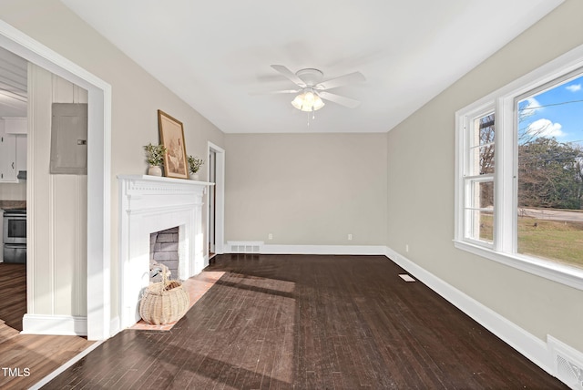 unfurnished living room with ceiling fan, wood-type flooring, and electric panel