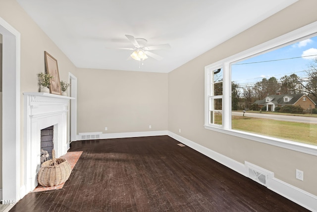 unfurnished living room with ceiling fan and dark hardwood / wood-style flooring