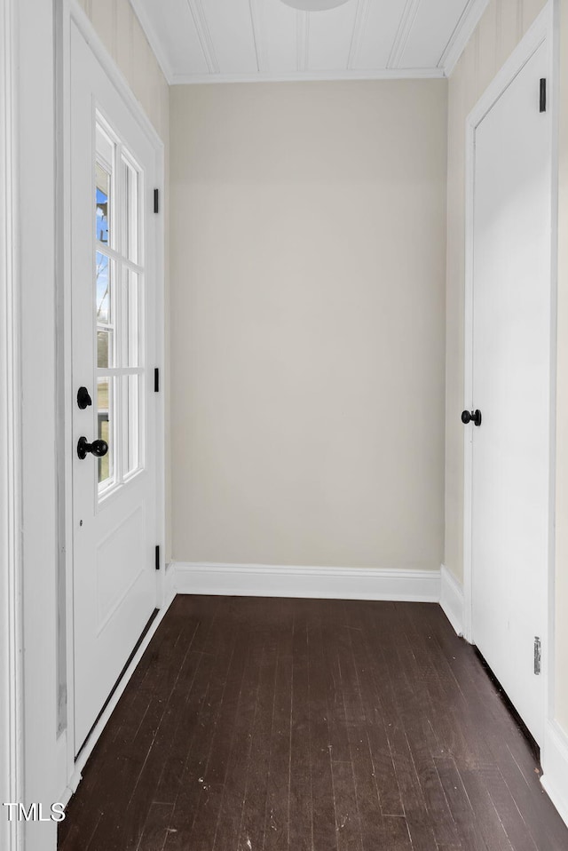 interior space with dark hardwood / wood-style floors and ornamental molding