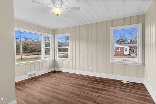 empty room with ceiling fan and dark wood-type flooring