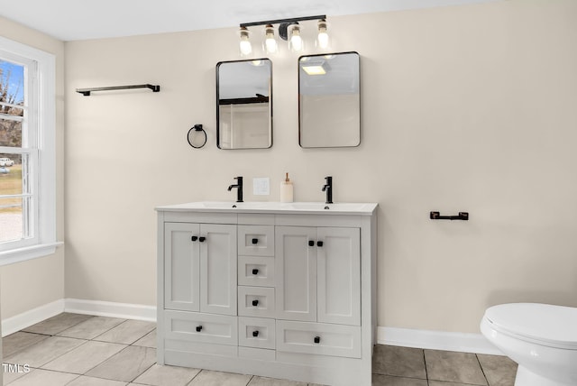 bathroom with tile patterned floors, vanity, and toilet