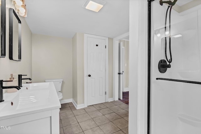 bathroom featuring tile patterned floors, a shower, vanity, and toilet