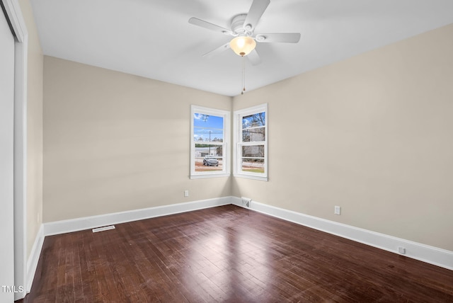 empty room featuring ceiling fan and dark hardwood / wood-style flooring