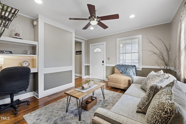 living room with ornamental molding, ceiling fan, and dark wood-type flooring