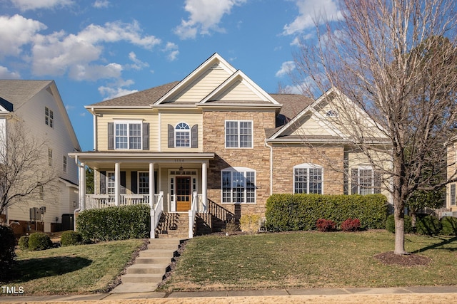 view of front of property featuring central AC, a front yard, and covered porch