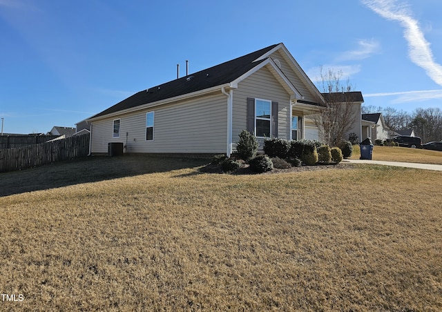 view of side of home with cooling unit and a yard