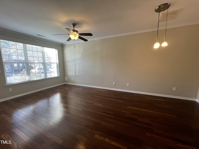 empty room featuring ceiling fan, dark wood-type flooring, and ornamental molding