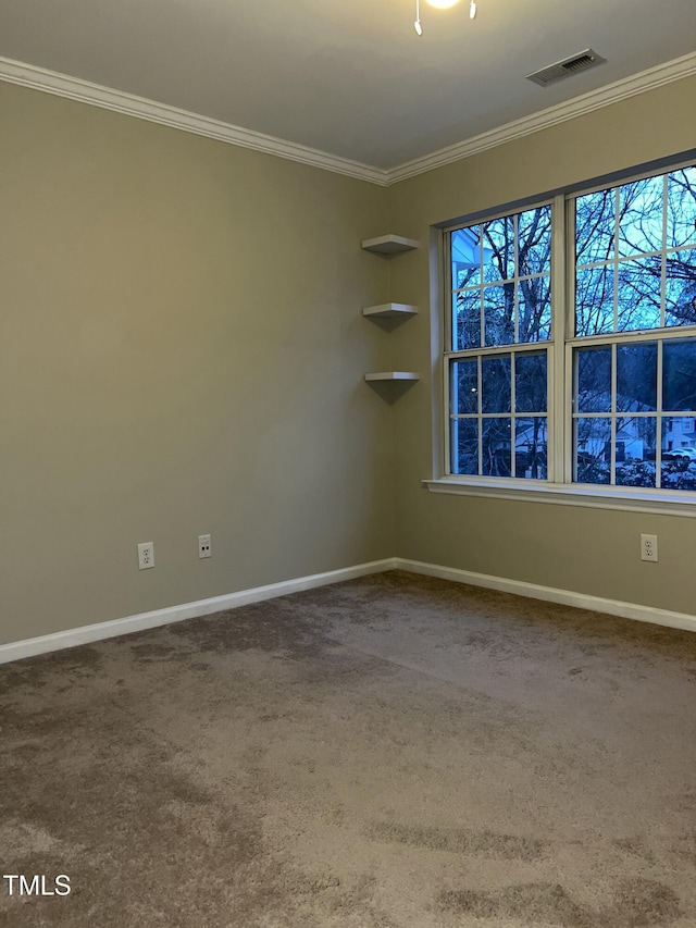 empty room with ornamental molding and carpet