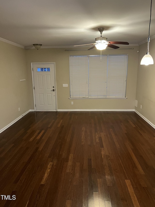 entryway with crown molding, dark wood-type flooring, and ceiling fan