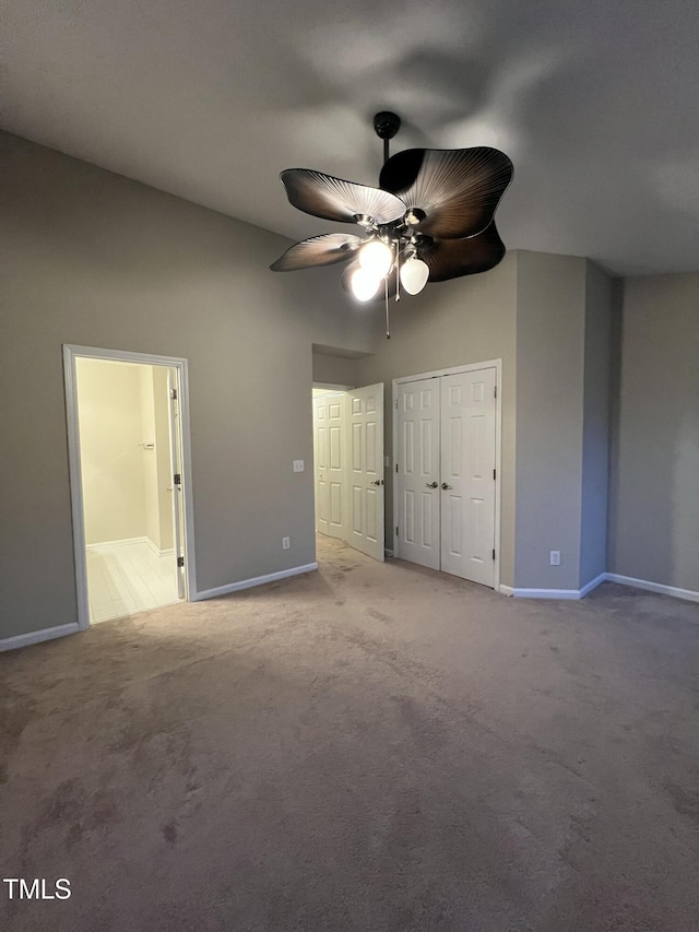 unfurnished bedroom with light carpet, connected bathroom, a closet, and ceiling fan