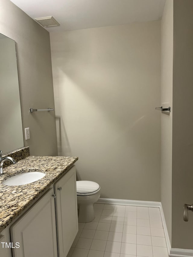 bathroom with tile patterned floors, vanity, and toilet