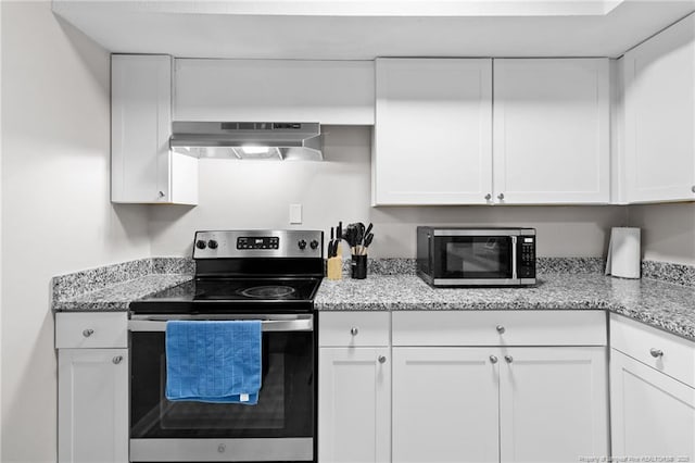 kitchen featuring appliances with stainless steel finishes, ventilation hood, white cabinetry, and light stone counters