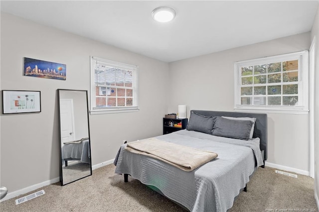 bedroom featuring light carpet