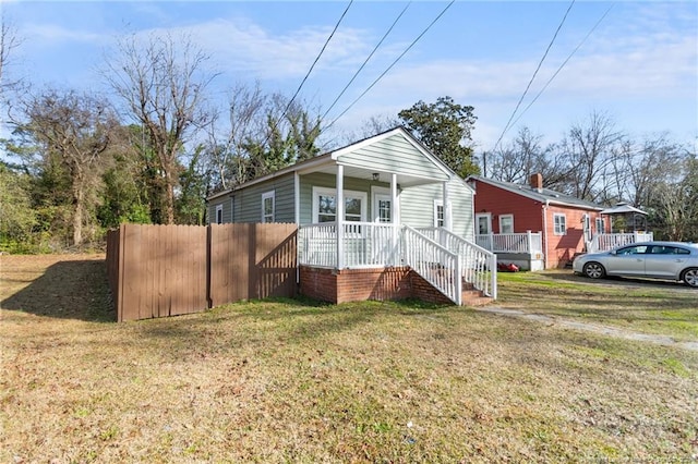 view of front of home with a porch and a front lawn