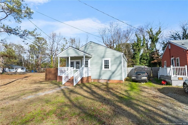 bungalow-style home with a front yard