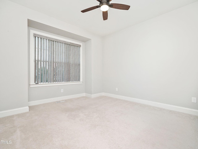 empty room with carpet flooring and ceiling fan