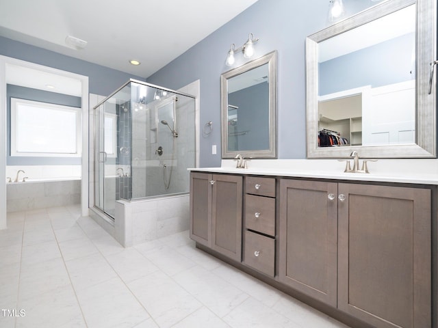 bathroom featuring vanity and independent shower and bath