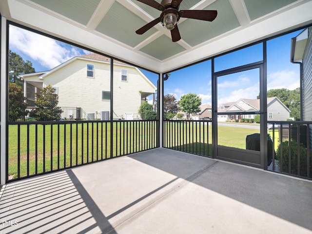 unfurnished sunroom with ceiling fan