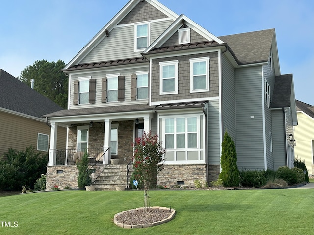 craftsman-style house featuring covered porch and a front lawn